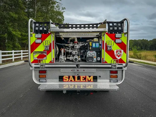 Straight rear exterior view showing chevron striping and rear-mounted pump compartment.